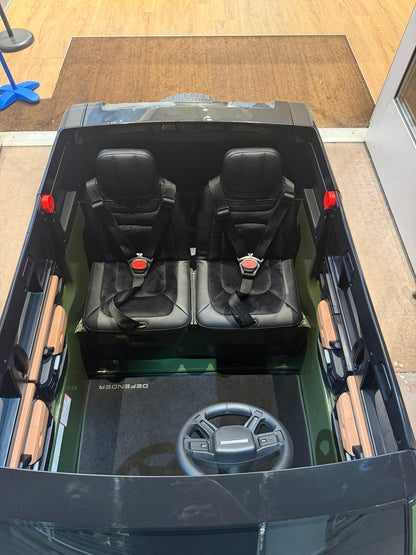 Top-down view of a black electric ride on land rover car for kids